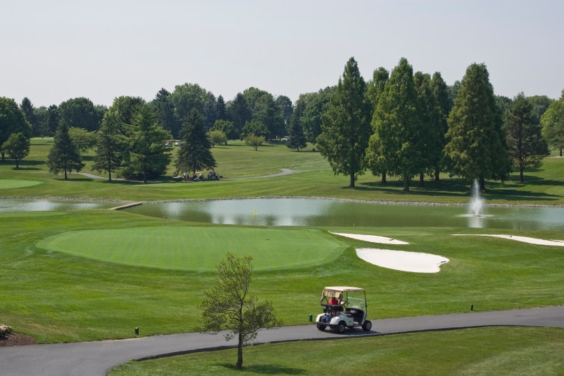 Golfers in golf cart at Hershey Pa golf course